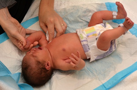 Little newborn baby (2 days old) having his first dry cleaning bath at hospital.