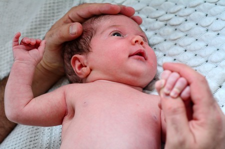 Hand of a young father touch his newborn baby (3 week old).(BW) copyspaceの写真素材