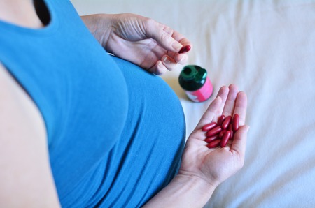 Pregnant woman Taking Medicine during pregnancy. Concept photo of women healthy life style and health care. copys paceの写真素材