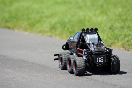4x4 Radio-controlled car drive on a path in the park.