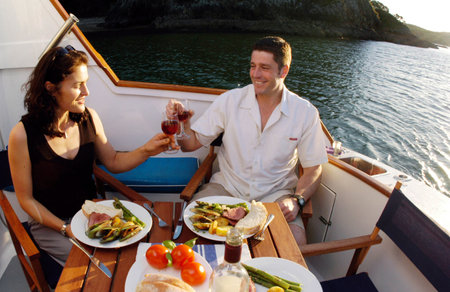 KERIKERI,NZ - DEC 10:Romantic couple having dinner on a yacht on Dec 10 2004.The Marriage rates in NZ have fallen in the past 40 years and a record low 20,900 marriages took place in 2011.のeditorial素材