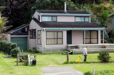 TAUPO BAY, NZ - MAY 11:Man carries a weedkiller sprayer spraying his home garden a on May 11 2011.New Zealand is among the countries experiencing a rapid rise in bed bug infestations.のeditorial素材