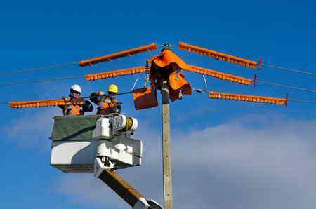MANGONUI,NZ - JUNE 11:Electrical workers repairs power pole on June 11 2013.NZ electricity sector uses mainly renewable energy sources such as hydro power,geothermal power and increasingly wind energyのeditorial素材