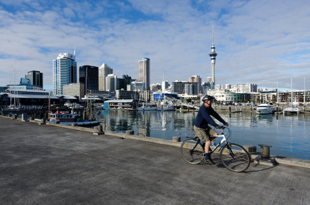 AUCKLAND - JUNE 02:Man cycle at Auckland Viaduct Harbor Basin on June 02 2013.It's a former commercial harbor turned into a development of mostly upscale apartments, office space and restaurants.のeditorial素材