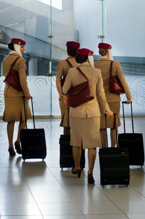 AUCKLAND - SEP 15:Emirates Airlines flight attendants in Auckland International Airport on Sep 15 2013.Emirates Airline was voted Airline of the Year in 2013.のeditorial素材