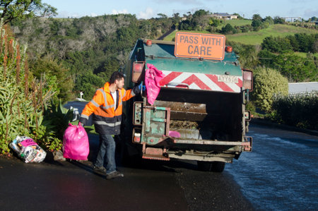 CABL BAY, NZ - JULY 25:Waste management worker on July 25 2013. The number of landfills in NZ decreased since 1995 from 327 to less than 100 today and most of New Zealand recycle is sent to China.のeditorial素材