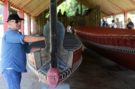 WAITANGI - JAN 07:Visitors at the Whare Waka Canoe house with 35 metre Waka war canoe on Jan 07 2014 in Waitangi National Reserve, Bay of Islands, Northland Region, New Zealand NZ.のeditorial素材