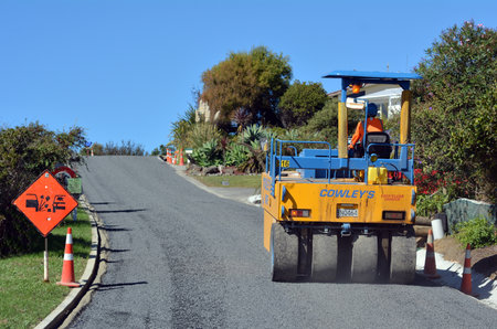 CABLE BAY, NZ - APR 01 2014:Road roller on asphalt pavement works (road repairing). There are more...