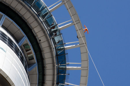 AUCKLAND, NZ - JAN 02: Person skywalk on Auckland sky tower building on Jan 02 2014. Skywalk is one of New Zealand's most thrilling tourist attractions in Auckland, New Zealand.のeditorial素材