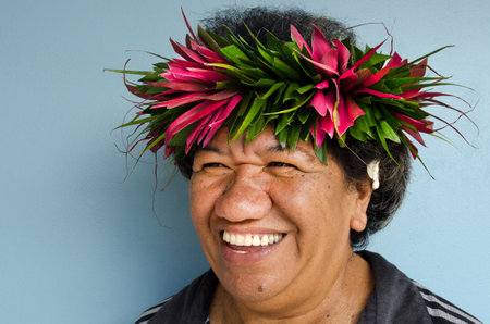 RAROTONGA - SEP 21:Exotic flowers on Cook Islanders woman hair on Sep 21 2013.The Cook Islands' main population centres are on the island of Rarotonga (14,153 in 2006).のeditorial素材