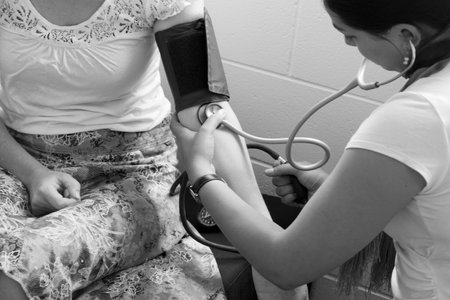 CABLE BAY, NZ:Midwife checks pregnant woman blood pressure on Dec 12 2013.In pregnancy, it's the fetal heart that builds up the fetal blood pressure to drive its blood through the fetal circulation. close up (BW)のeditorial素材