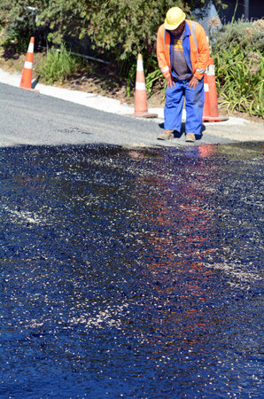 CABLE BAY, NZ - APR 01 2014:Road worker during roadwork. There are more than four million miles of highways and roads in the U.S alone.のeditorial素材
