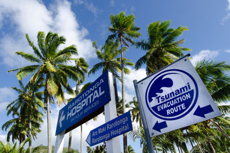RAROTONGA - SEP 21:Tsunami evacuation route sign on Sep 21 2013.Cook Islands are in danger of earthquake generated a Tsunami waves from New Zealand or Chile.のeditorial素材
