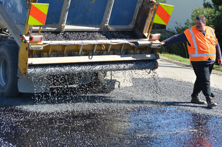CABLE BAY, NZ - APR 01 2014:Road worker during roadwork.The Road Maintenance crew has the responsibility for the day-to-day maintenance needs of the roadのeditorial素材