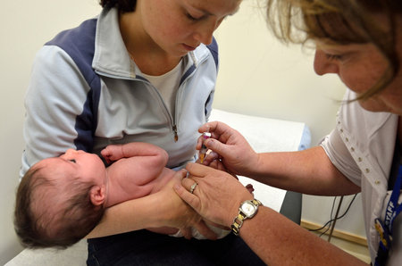 AUCKLAND - JULY 23 2014:Newborn baby (Naomi Ben Ari age 0)vaccination.As of 2013,UK immunization program consists 10 injections by the age of 2 rather than 25 previously.のeditorial素材