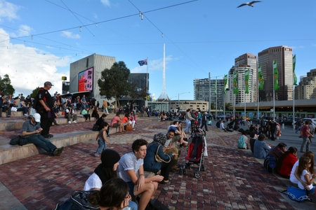 MELBOURNE - APR 13 2014:Visitors at the Federation Square.It located at the heart of Melbournes CBD with size of an entire city block.It's home to major cultural attractions and world-class events.のeditorial素材