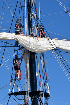 AUCKLAND - JUNE 01 2014:Sailors climb on to of the mast of Spirit of New Zealand. It's a tall ship with steel-hulled, three-masted barquentine that was built by the Spirit of Adventure Trust in 1986.のeditorial素材