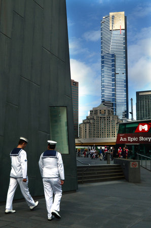 MELBOURNE - APR 13 2014:Australian navy sailors in federation square with the Eureka Tower at the background,It is currently the 98th tallest building in the world.のeditorial素材