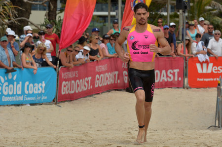 GOLD COAST, AUS - NOV 2 2014:Caine Eckstein race in Coolangatta Gold 2014.The five-time Gold champion was forced out of the race due to the pain of a torn bicep around 30km into the event.のeditorial素材