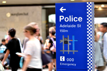 BRISBANE, AUS - SEP 25 2014:Australian people pass by Police Station sign.Gold Coast police on high terror alert warned to be hyper vigilant and patrol local mosques and critical infrastructure sitesのeditorial素材