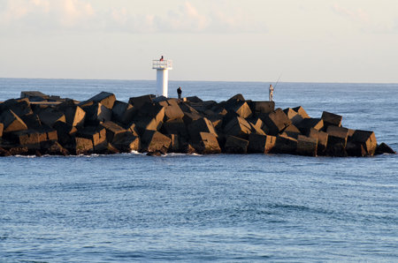 GOLD COAST - OCT 13 2014:Fisherman at Seaway.It's the main navigation entrance from the Pacific Ocean into Gold Coast Broadwater. It's one of Australiaâs most significant coastal engineering projects.のeditorial素材