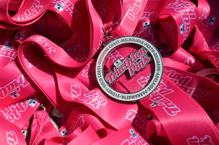 GOLD COAST - SEP 27 2014:Triathlon Pink medals.It's an Australian sporting community event for women raising funds for charities who provide breast cancer support and researchのeditorial素材