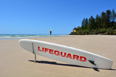 COOLANGATTA - OCT 07 2014:Lifeguard paddle board in Gold Coast Australia.Australian Lifeguards are world-renown for their high levels of skill and knowledge in accident prevention and rescue responseのeditorial素材