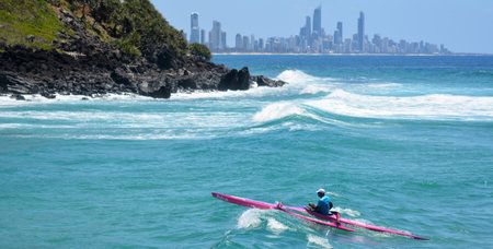 SURFERS PARADISE - NOV 09 2014:Man canoeing in Surfers Paradise.It one of Australia's iconic coastal tourist destinations, drawing about 10 million tourists every year from all over the world.のeditorial素材