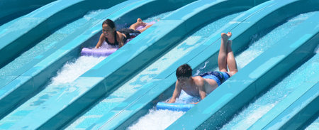 GOLD COAST, AUS - OCT 30 2014:Visitors rids on Super 8 Aqua Racer in Wet'n'Wild Gold Coast water park. In 2009, the park received 1,095,000 visitors ranking it first in Australia and eighth in the worldのeditorial素材