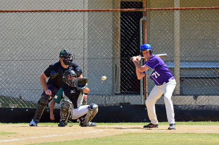 GOLD COAST, AUS - OCT 19 2014:Men play baseball in the park.Basball was invented almost 200 years...