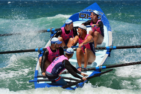 SURFERS PARADISE - NOV 08 2014:Surf rowers.More than 400 surf rowers and 55 surfboats hit the waves at Surfers Paradise Beach during the open Navy Australian Surf Rowers League season.のeditorial素材