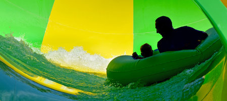 GOLD COAST, AUS - OCT 30 2014:Father and son having fun in Wet'n'Wild Gold Coast water park. In 2009, the park received 1,095,000 visitors ranking it first in Australia and eighth in the worldのeditorial素材