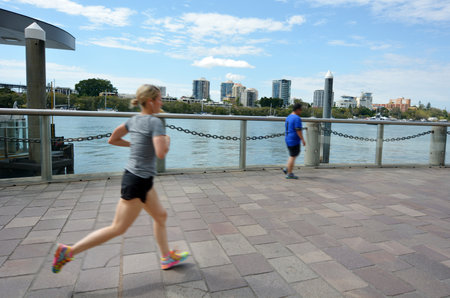 BRISBANE, AUS - SEP 26 2014:Runners runs on Brisbane riverside walk.It's a popular network of riverwalk pavements along the banks of the Brisbane River.のeditorial素材