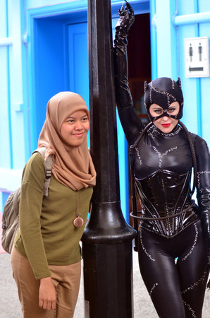 GOLD COAST, AUS -  NOV 06 2014:Muslim woman with Catwoman in Movie World Gold Coast Queensland Australia.Catwoman was ranked 23rd in Comics Buyer's Guide's '100 Sexiest Women in Comics' list.のeditorial素材