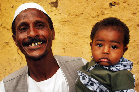 Egyptian Nubian man and his baby in a village on the Nail river, Egypt.のeditorial素材