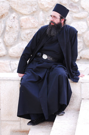 QUMRAN, ISR - DEC 14:Christian pilgrim priest visit Qumran Caves on December 14 2008.The Dead Sea Scrolls were discovered in eleven caves in Qumran near the Dead Sea between the years 1947 and 1956.のeditorial素材