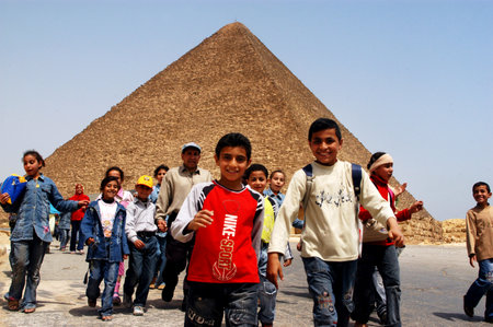 GIZA - APRIL 27: Egyptian syout under the Pyramid of Khufu in Giza, Egypt on April 27 2007 .It was the tallest man-made structure in the world for over 3,800 yearsのeditorial素材