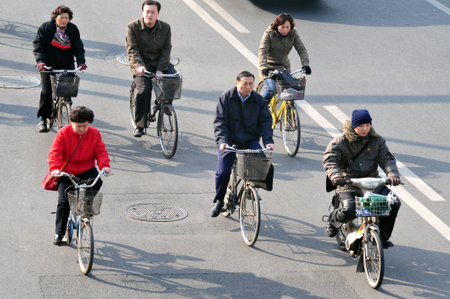 BEIJING - MARCH 11: Chinese people rids bicycles on March 11 2009 in Beijing,China.There are over a half billion bicycles in China.のeditorial素材