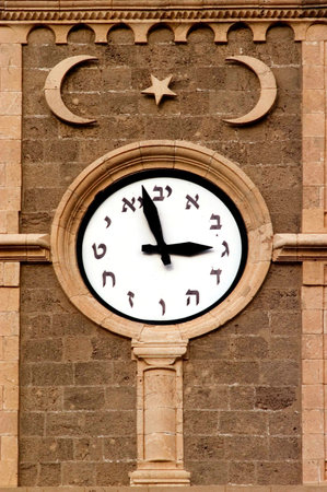 The old clock tower of Akko , Ottoman landmark building - Han El-Umdan, Acre, Israel