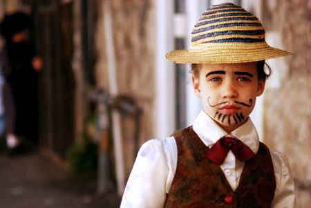 JERUSALEM - MARCH 05: Israeli child dressed up with an old man costume during the Jewish holiday Purim on March 05 2007 in Mea Shearim in Jerusalem, Israel.のeditorial素材