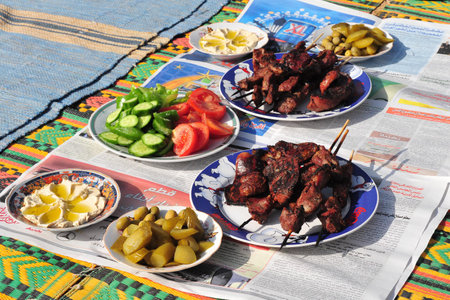 LAKIYA,ISR - DEC 12:Cooked lamb meat and salads on Eid al-Adha, Dec 8 2008.The festival is celebrated by sacrificing a lamb or other animal and distributing the meat to relatives, friends, and the poor.のeditorial素材