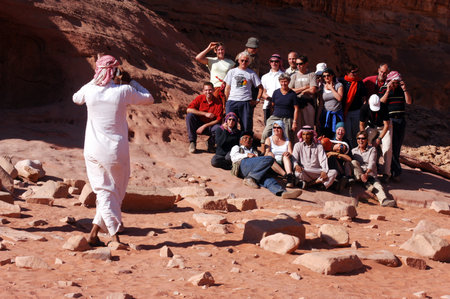 WADI RUM-NOV 10:Jordanian man photograph tourist in Wadi Rum,Jordan on November 10 2007.It's one of Jordans important travel destinations among the massive and special rock formations.のeditorial素材