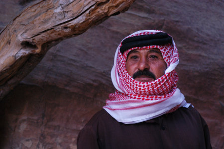 PETRA - NOV 09:A Jordanian man wearing red Keffiyeh in Petra, Jordan on November 09 2007.It has been used by arabs throughout the centuries and was used as a symbol of honor and tribal identification.のeditorial素材