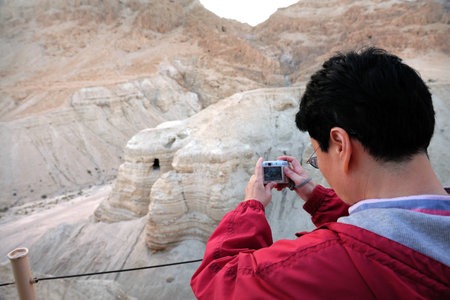 QUMRAN, ISR - DEC 14:Visitor take pictures of Qumran Caves on December 14 2008.The Dead Sea Scrolls were discovered in eleven caves in Qumran near the Dead Sea between the years 1947 and 1956.のeditorial素材