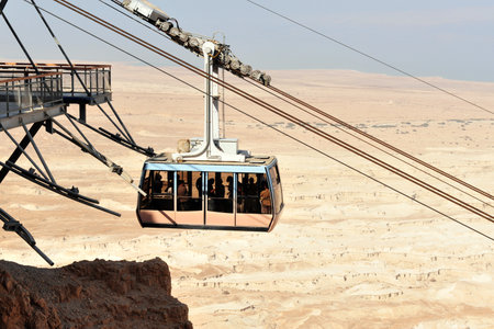 MASADA,ISR - SEP 17:The cable car to Masada stronghold on September 17 2008 in Judea Desert, Israel.Masada considered as most popular tourist destination in Israel, outside of Jerusalem.のeditorial素材