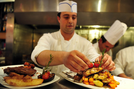 ASHKELON - JULY 27: Chef prepares delicious food in a restaurant on July 27 2009, in Ashkelon, Israel.のeditorial素材