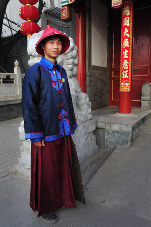BEIJING-MARCH 12:Chinese man wears traditional silk outfit on Mar 12 2009 Beijing,China.Silk is one of the oldest textile fibers known to man.It has been used by the Chinese since the 27th century BC.のeditorial素材
