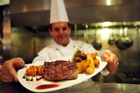 ASHKELON - JULY 27: Chef prepares delicious food in a restaurant on July 27 2009, in Ashkelon, Israel.のeditorial素材