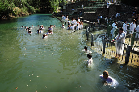 TIBERIAS - MAY 18:Christian pilgrims during mass baptism ceremony at the Jordan River in North Israel on May 18 2009.In Christian tradition, Jesus was baptised in the River Jordan by John the Baptist.のeditorial素材