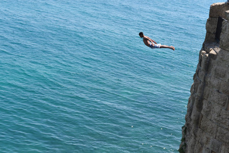 Arab boy jumps from the top of the ancient walls Acre Akko, Israel.のeditorial素材